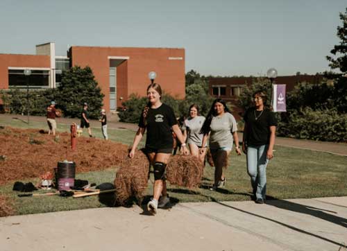 FFA students lay pine straw on the Macon Campus.
